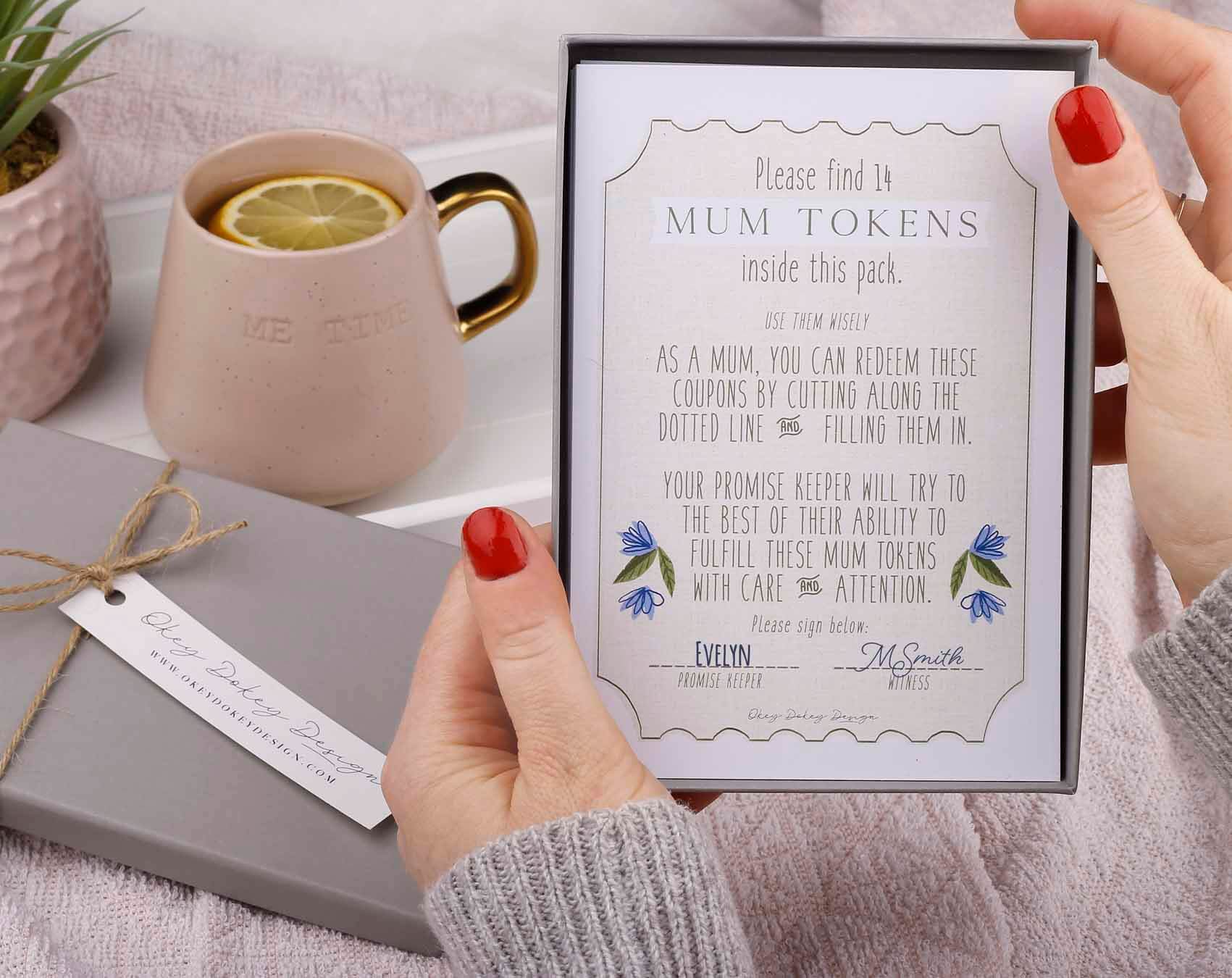 Mothers Day Ideas featuring a gift of mum tokens presented in a decorative box with a coffee cup in the background.