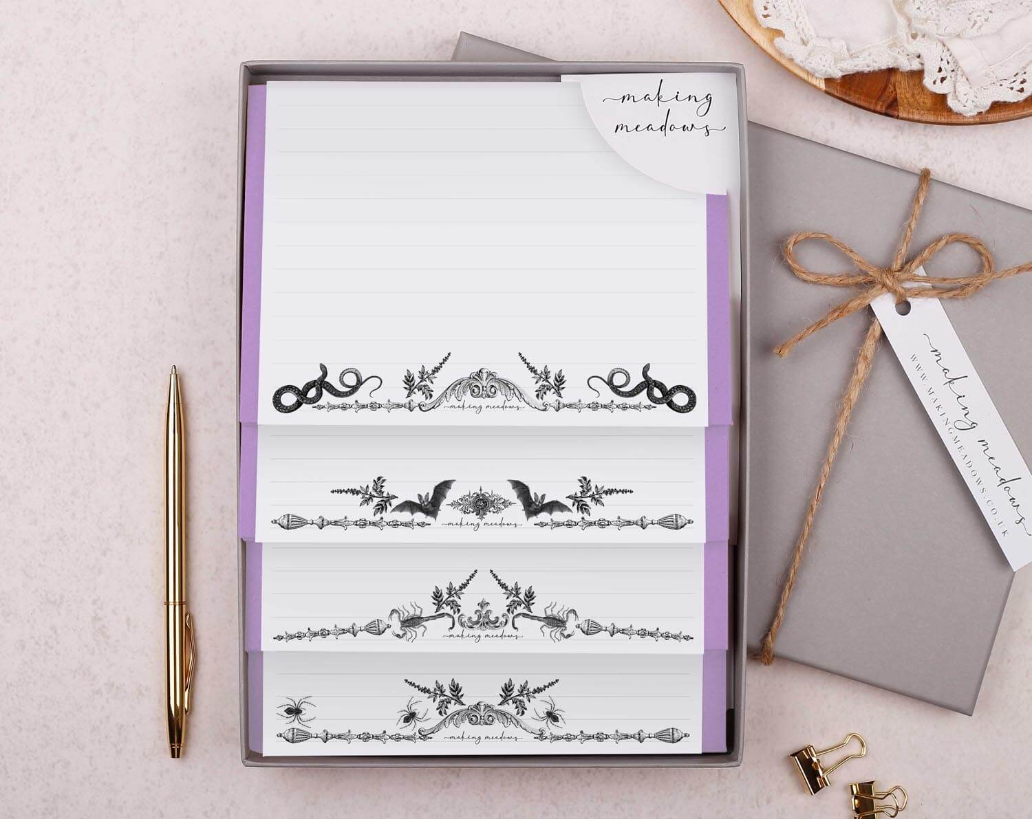 Gothic writing set with bats, snakes, scorpions, and spiders