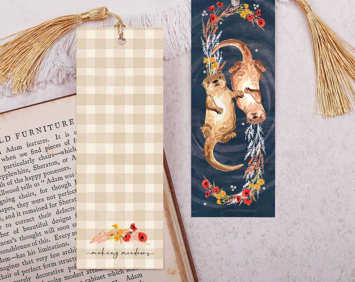 Pretty Bookmark featuring two designs: a plaid bookmark and an illustrated otter bookmark with tassels.