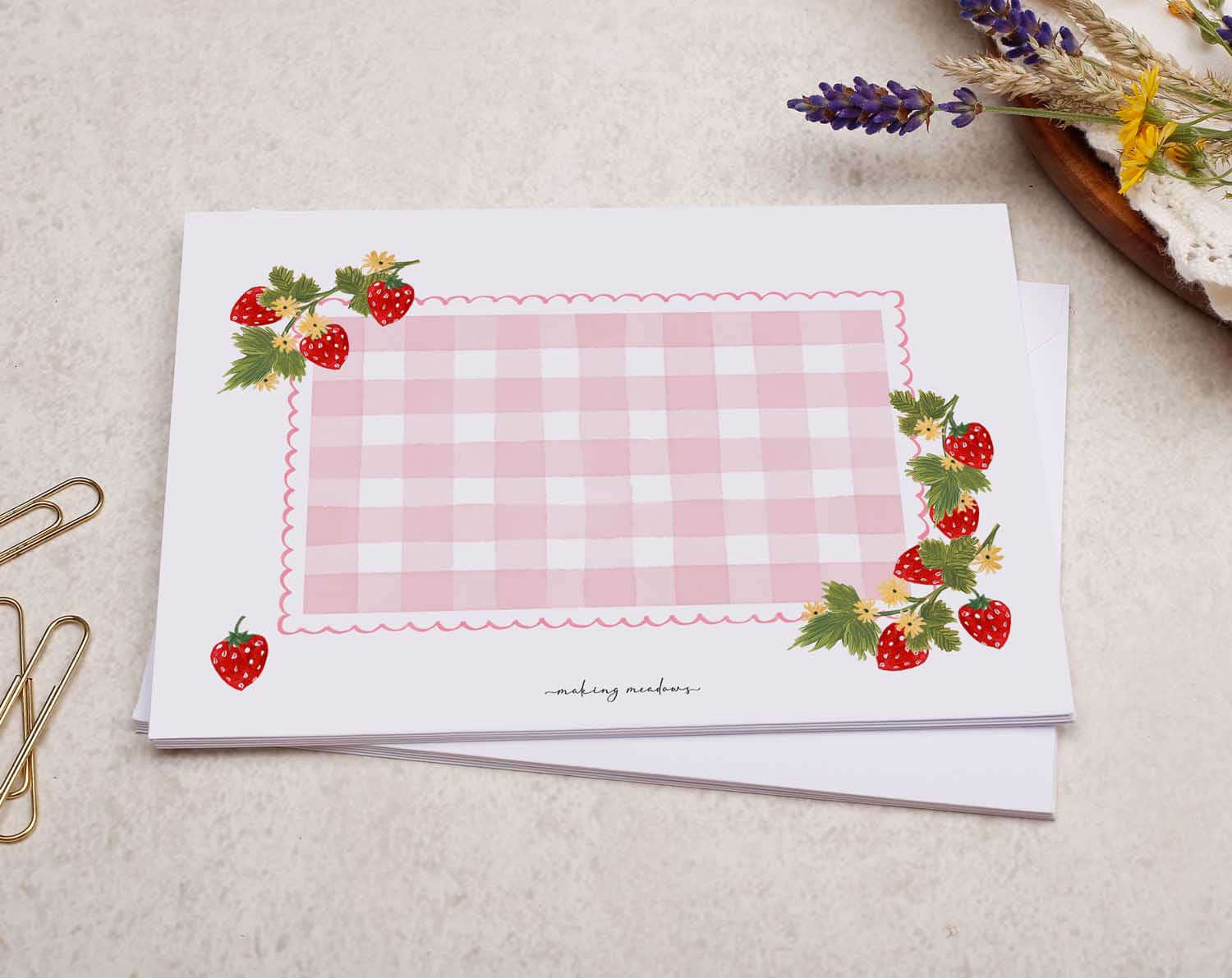 Patterned Envelopes featuring a pink checkered design and decorated with strawberries, perfect for sending thoughtful notes.