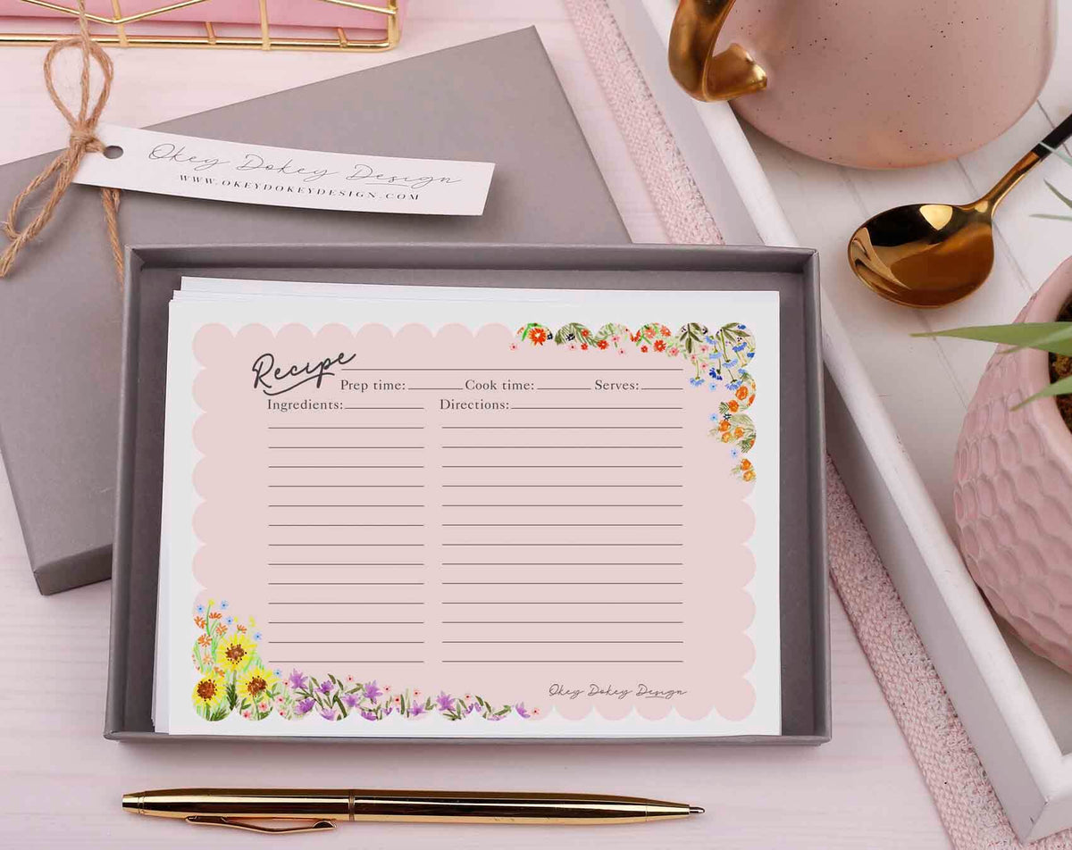 A collection of Blank Recipe Cards displayed in a box, featuring floral designs, perfect for writing favorite recipes.