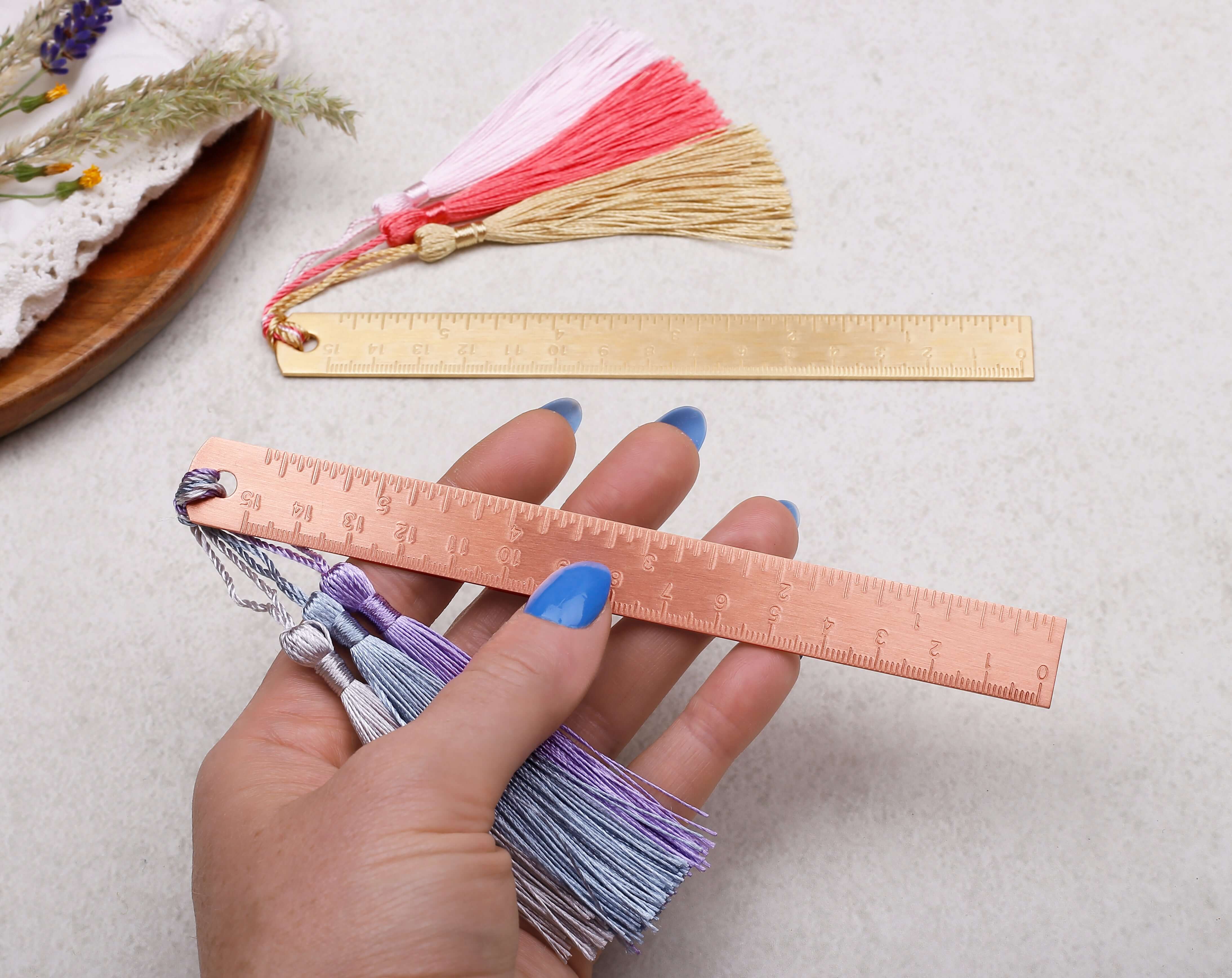 rose gold and gold metal rulers with tassels