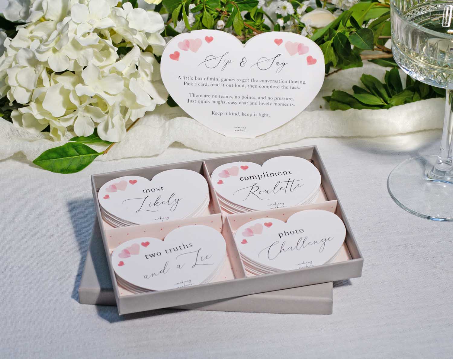 Wedding Table Games featuring a box of heart-shaped cards for guests to play during the reception.