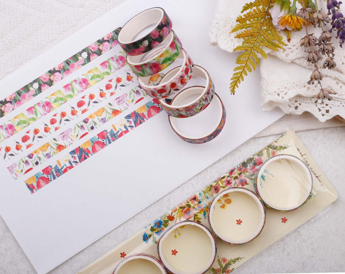 Decorative Washi Tape collection displayed with floral designs and colorful patterns on stationery.