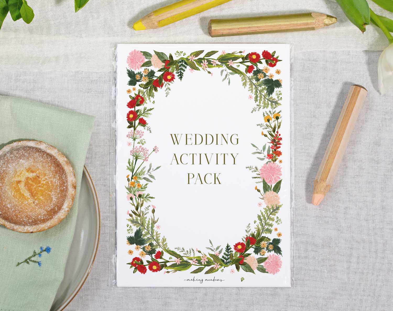 Boho Wedding Kids Activity Pack beautifully designed with floral borders and colorful pencils on a table setting.