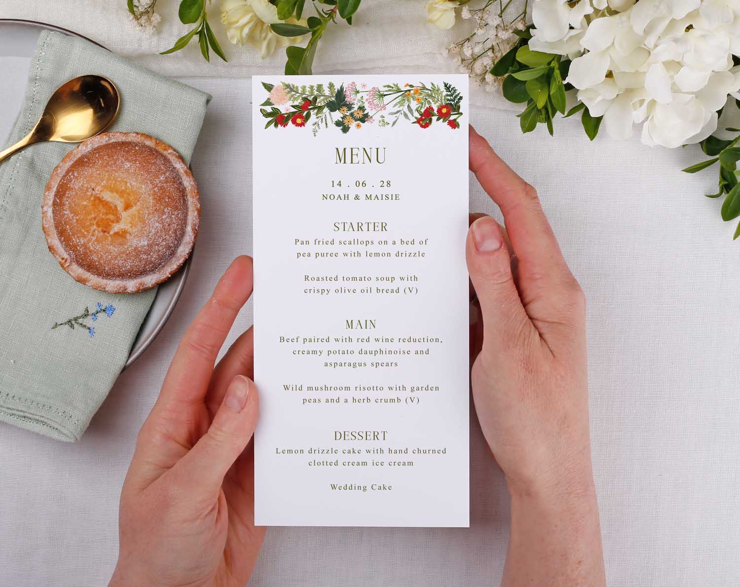 Boho Wedding Menus displayed on a table with floral design, showcasing meal options for guests at a wedding.