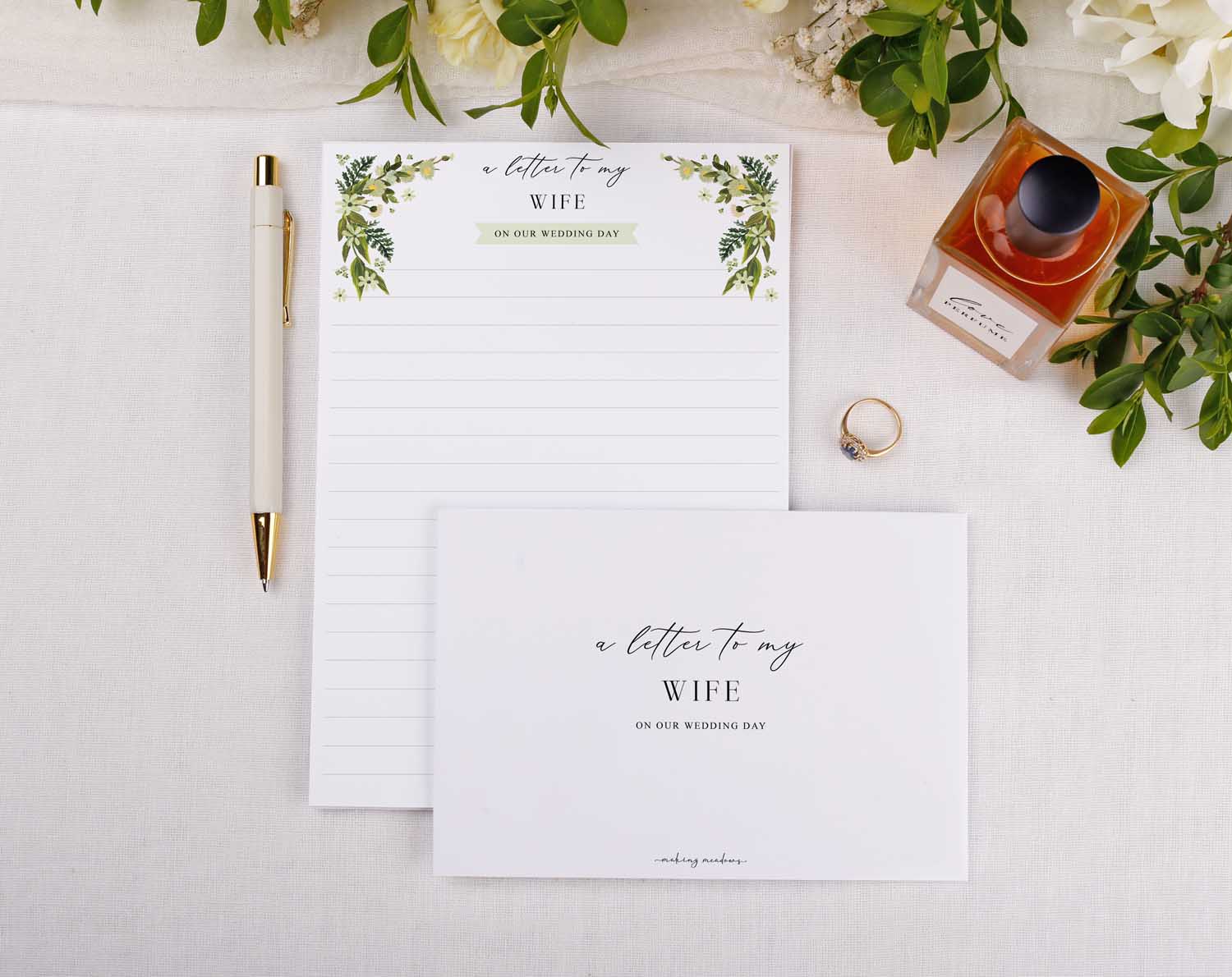 Botanical Wedding Letter to My Wife and elegant pen on a table with floral decor and a wedding ring.