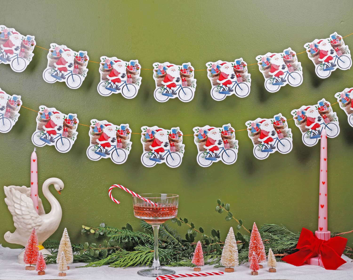 Festive Santa Christmas Bunting featuring Santa on bicycles, perfect for holiday decorations.