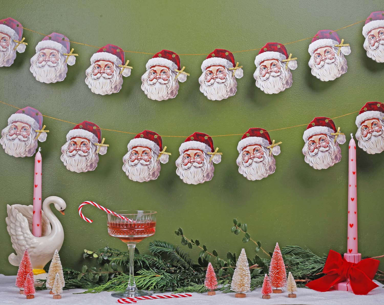 Father Christmas Bunting displayed with festive decor, featuring jolly Santa Claus faces on a green backdrop.
