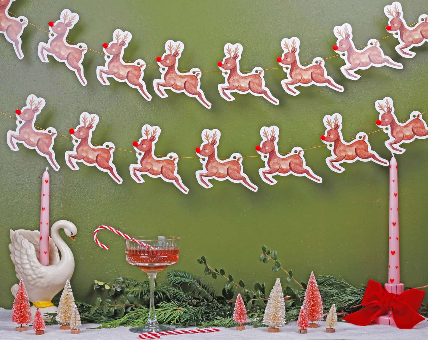 Reindeer Christmas Bunting hanging decoratively against a green wall, creating a festive holiday atmosphere.