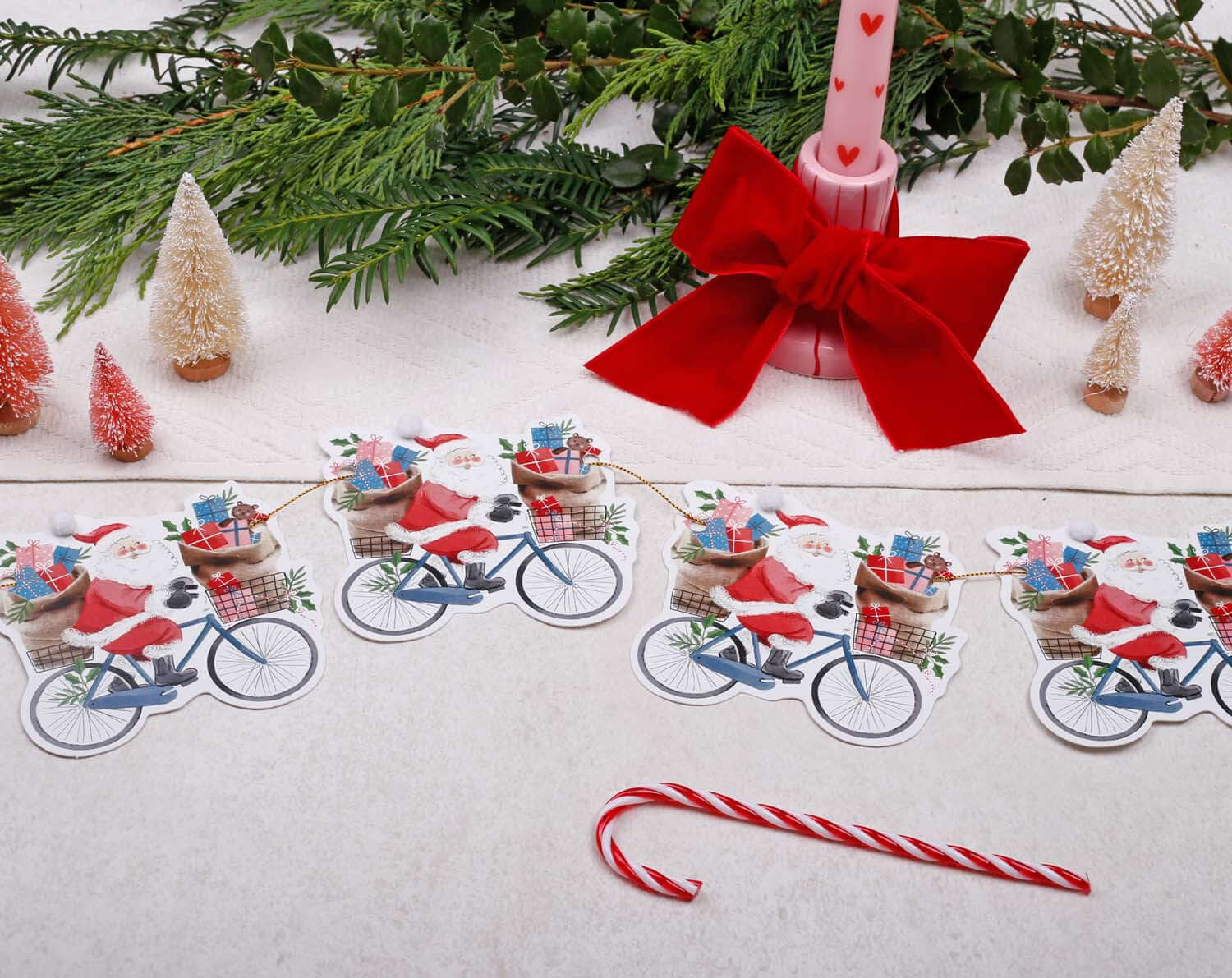 Santa Christmas Bunting featuring cheerful Santa on bicycles with gifts, perfect for festive decoration.