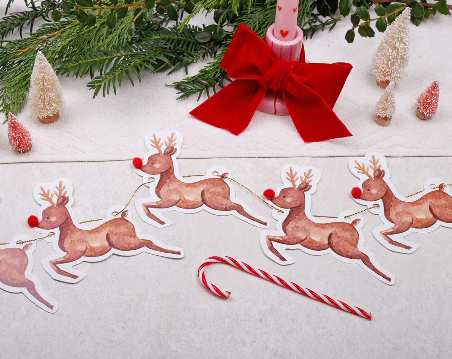 Reindeer Christmas Bunting with playful reindeer flags, festive decorations, candy cane, and holiday greenery.