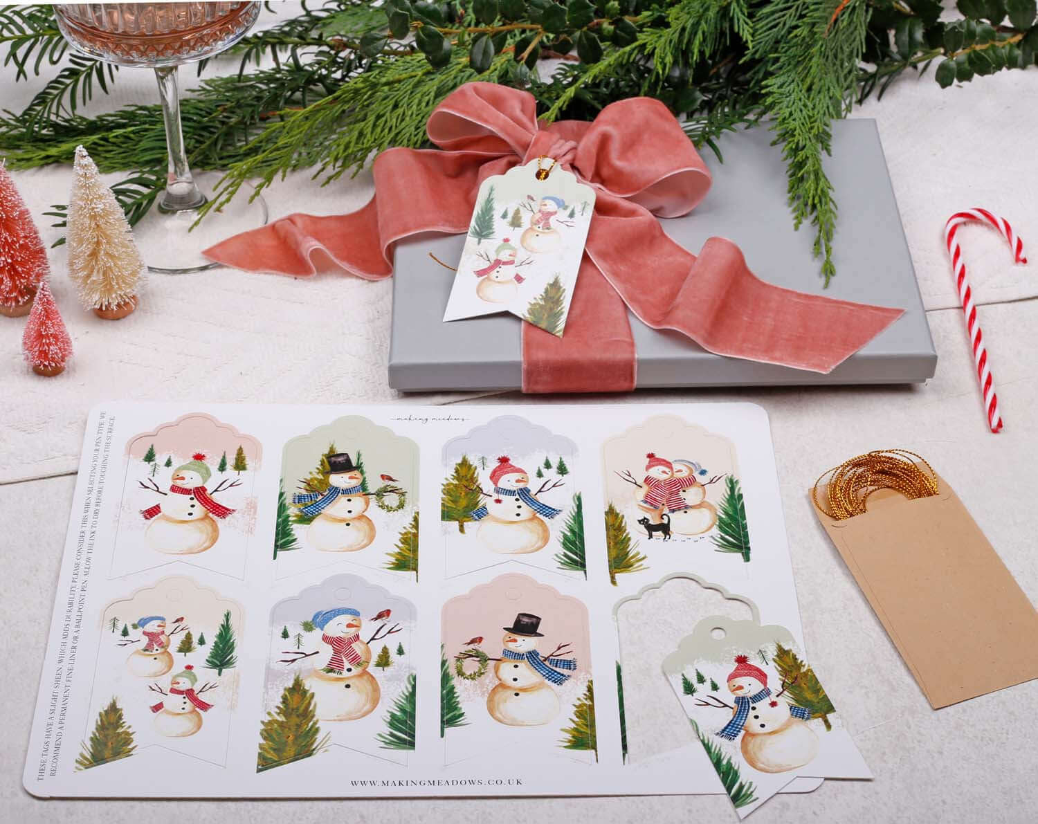 Snowman Christmas Gift Tags - 16 Pack with cheerful snowman illustrations and gold twine for festive gift wrapping.