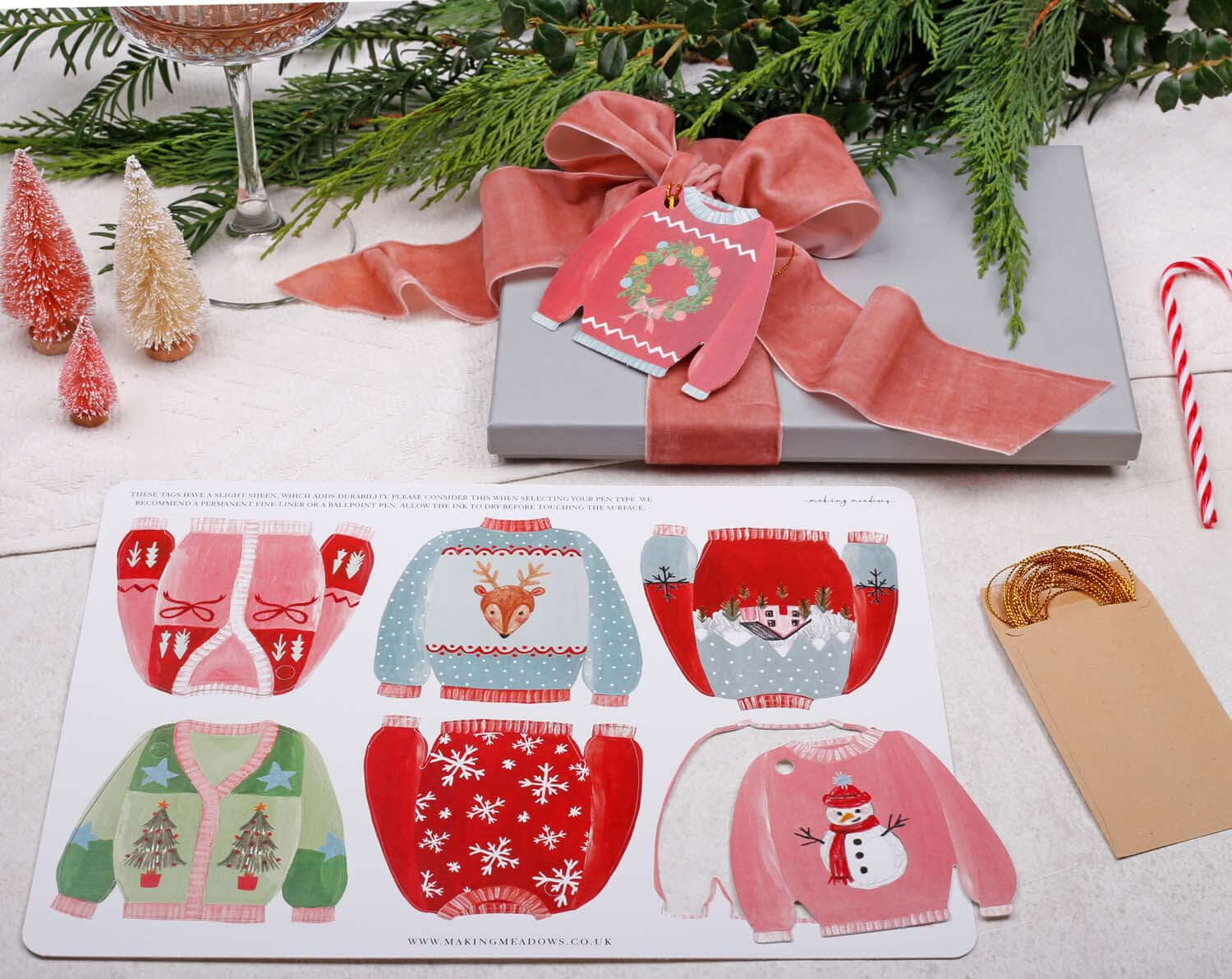 Christmas Jumper Gift Tags - 12 Pack featuring vibrant sweater designs on a festive gift.