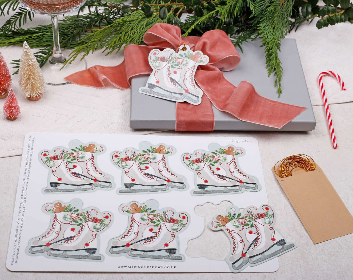 Ice Skating Christmas Gift Tags - 12 Pack featuring vintage skater illustrations and elegant gold twine for festive wrapping.