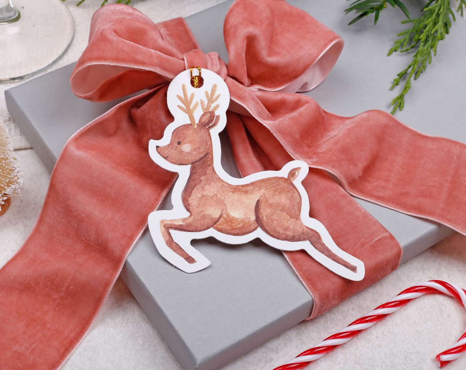Reindeer Christmas Gift Tags on a beautifully wrapped gift with a ribbon for a festive holiday touch.
