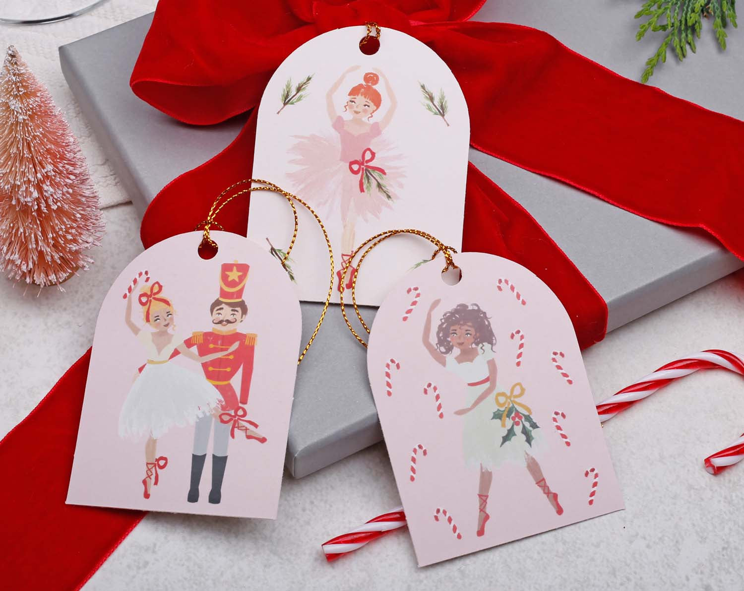 Nutcracker Christmas Gift Tags featuring ballet dancer designs on pink gift tags with festive decorations.