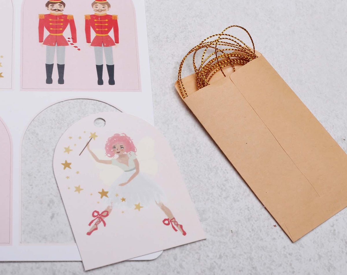 Nutcracker Christmas Gift Tags featuring a pink ballet dancer and a kraft envelope for festive labeling.