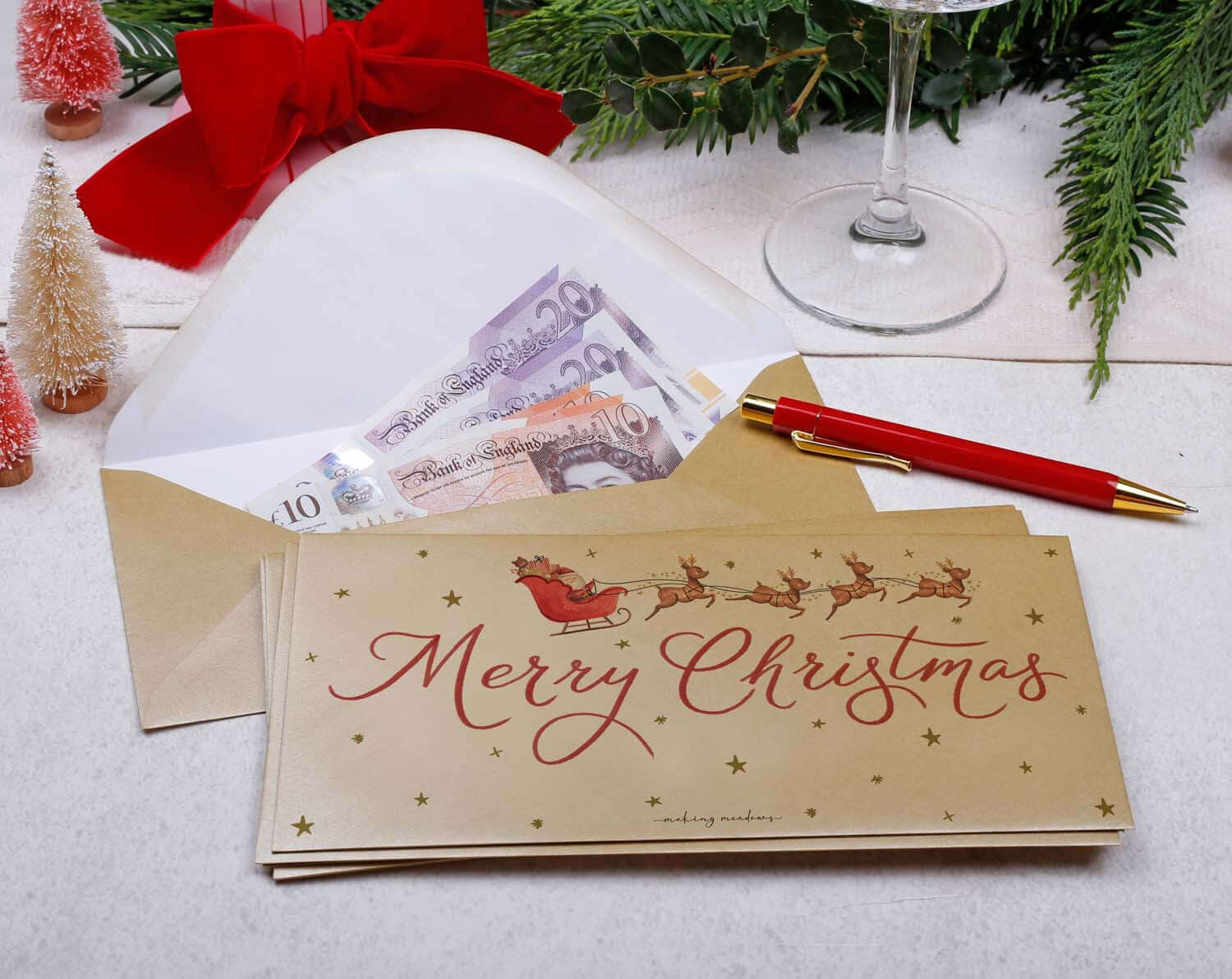 Father Christmas Money Envelopes featuring Santa on sleigh, holding cash, perfect for Christmas gifting.