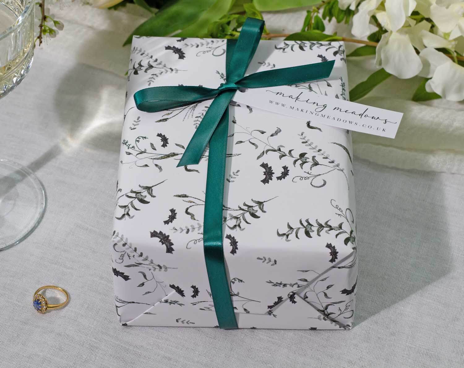 Elegant gift wrapped in Gothic Wedding Wrapping Paper with a teal ribbon, perfect for wedding celebrations.