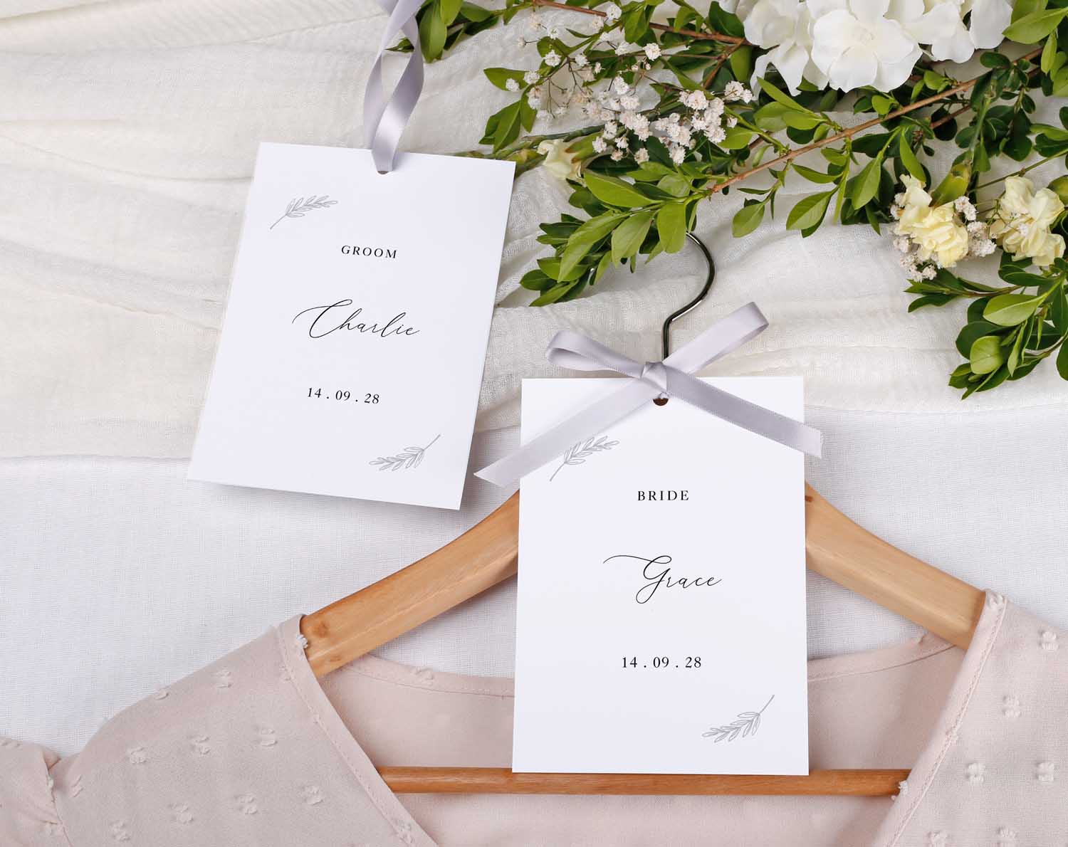 Minimalist Wedding Hanger Tags for bridal party with bride and groom name tags on a hanger.