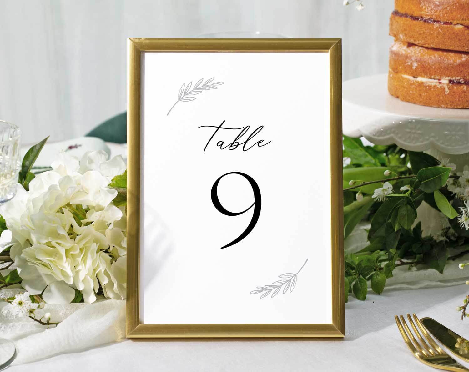 Minimalist Wedding Table Numbers in a gold frame displaying Table 9 at a beautifully arranged reception table.