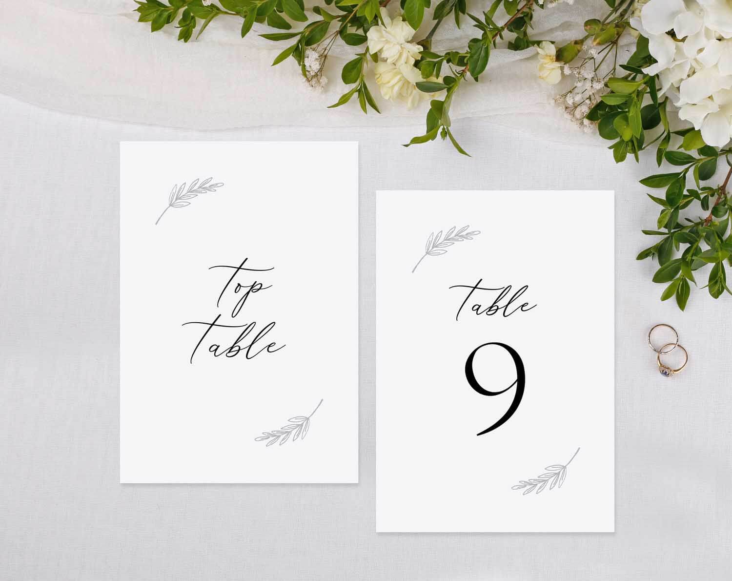 Minimalist Wedding Table Numbers displayed on a reception table with floral accents.