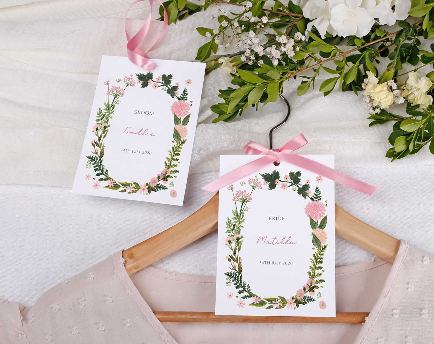 Pink Floral Wedding Hanger Tags for bride and groom with floral design and personalized names.