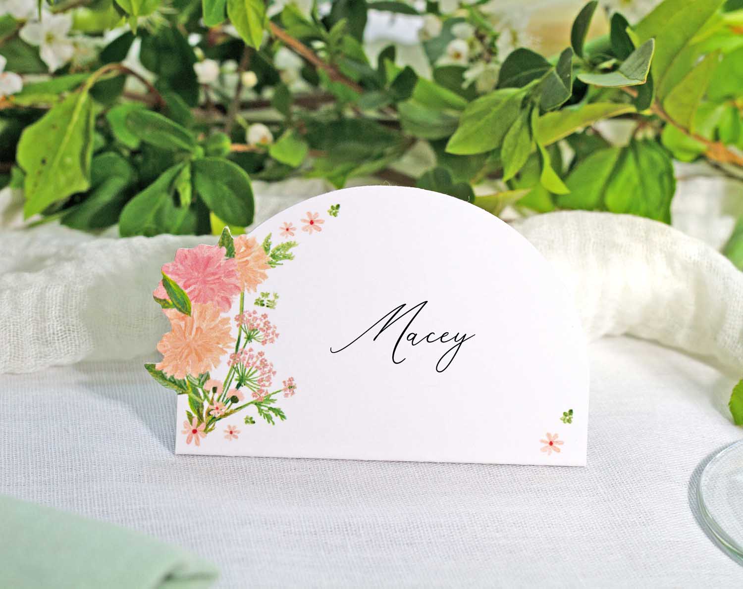 Pink Floral Wedding Place Cards with a cluster of pink flowers and elegant name writing.