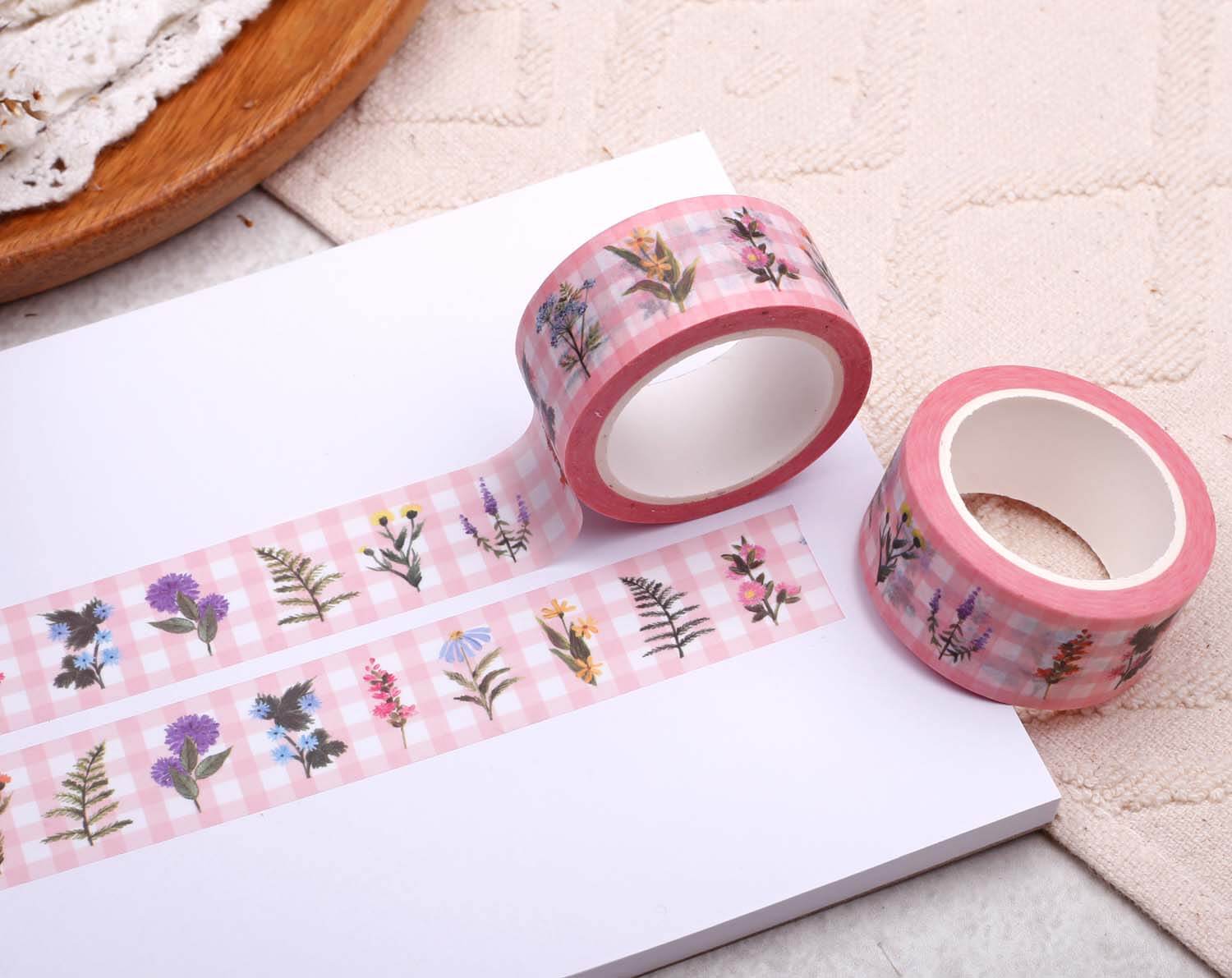 Pink Gingham Floral Washi Tape on a white surface, featuring vibrant floral designs on a pink gingham background.