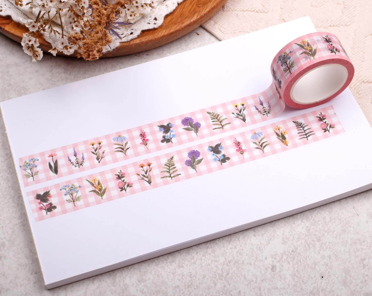 Pink Gingham Floral Washi Tape displayed on a white paper surface, showcasing floral designs on pink gingham background.