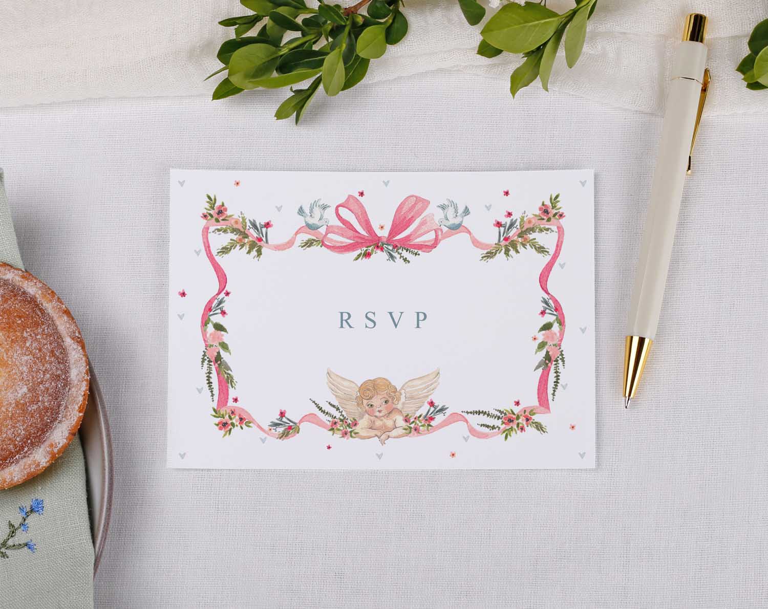 Vintage Wedding RSVP Cards with floral design and pink bow detail on a table setting.