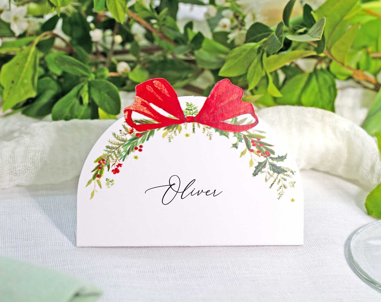 Winter Wedding Place Cards featuring a festive red bow and floral design perfect for table settings.