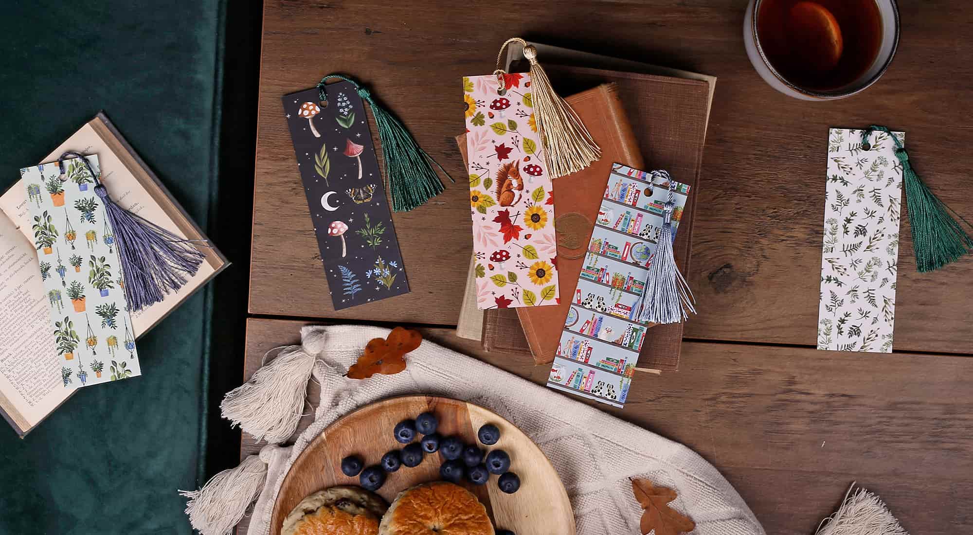 double sided bookmarks with different coloured tassels on a desk
