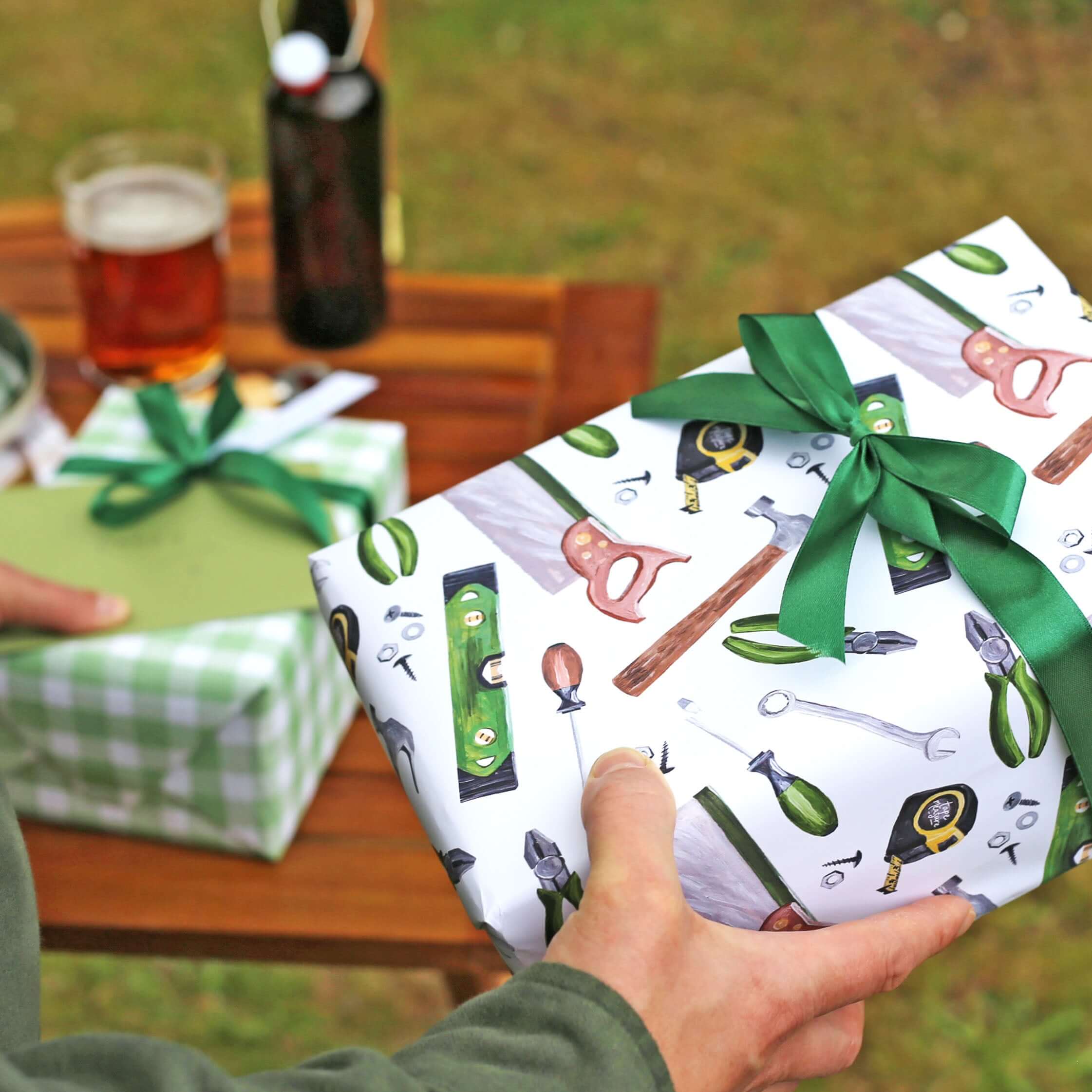 man holding luxury wrapping paper with builder tools on