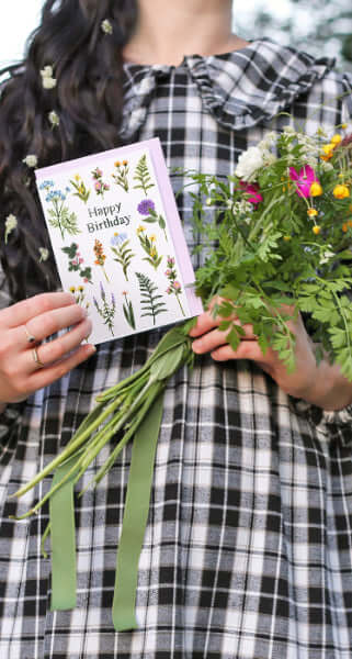 girl holding making meadows greeting card