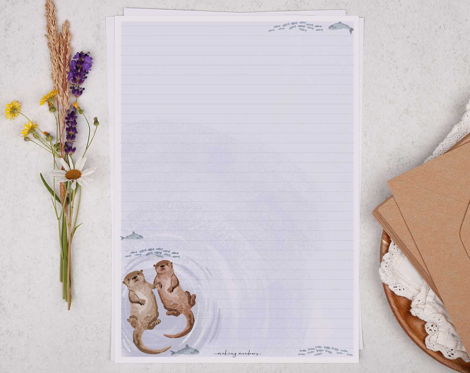 A4 writing paper with otters holding hands. Stationery designed by Making Meadows