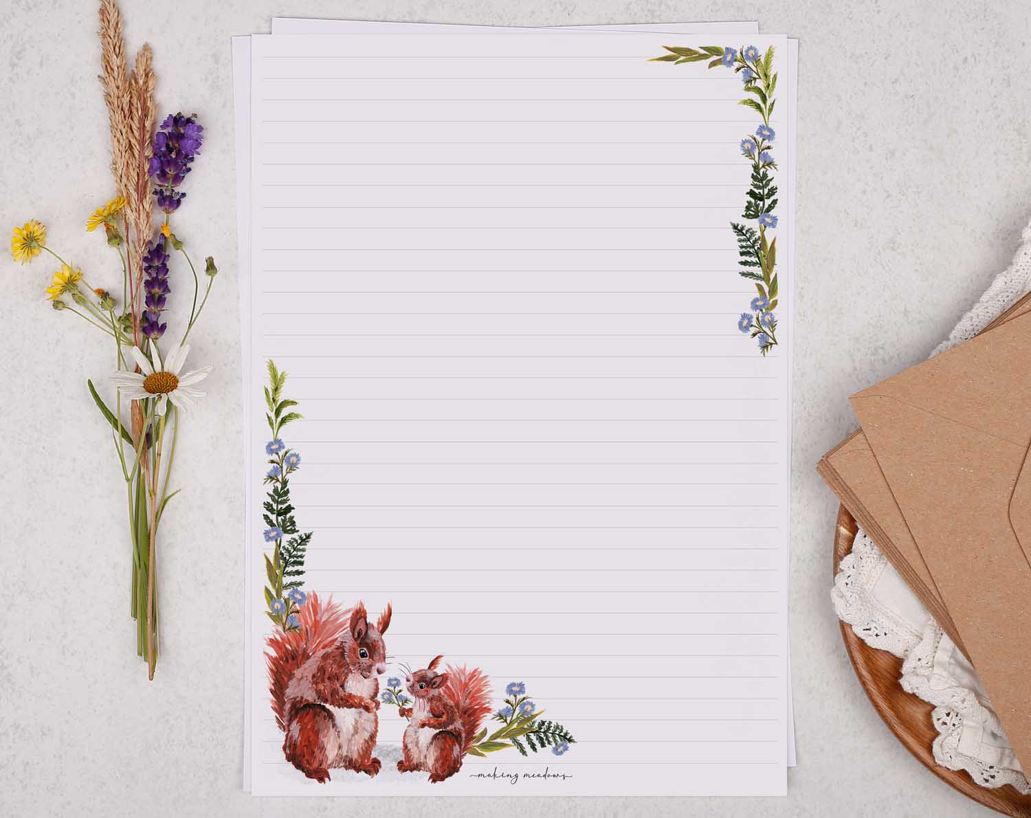 A4 writing paper with red squirrels and blue floral border. Stationery designed by Making Meadows