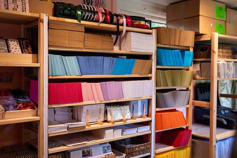 Image of shelves filled with colorful stationery supplies in a UK Stationery Business.