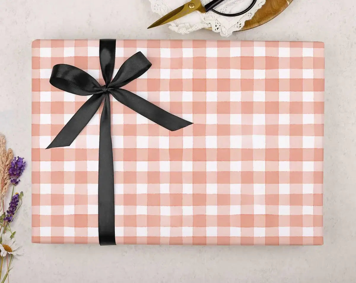 PANTONE Colour Of The Year gift box wrapped in peach and white gingham pattern with black ribbon