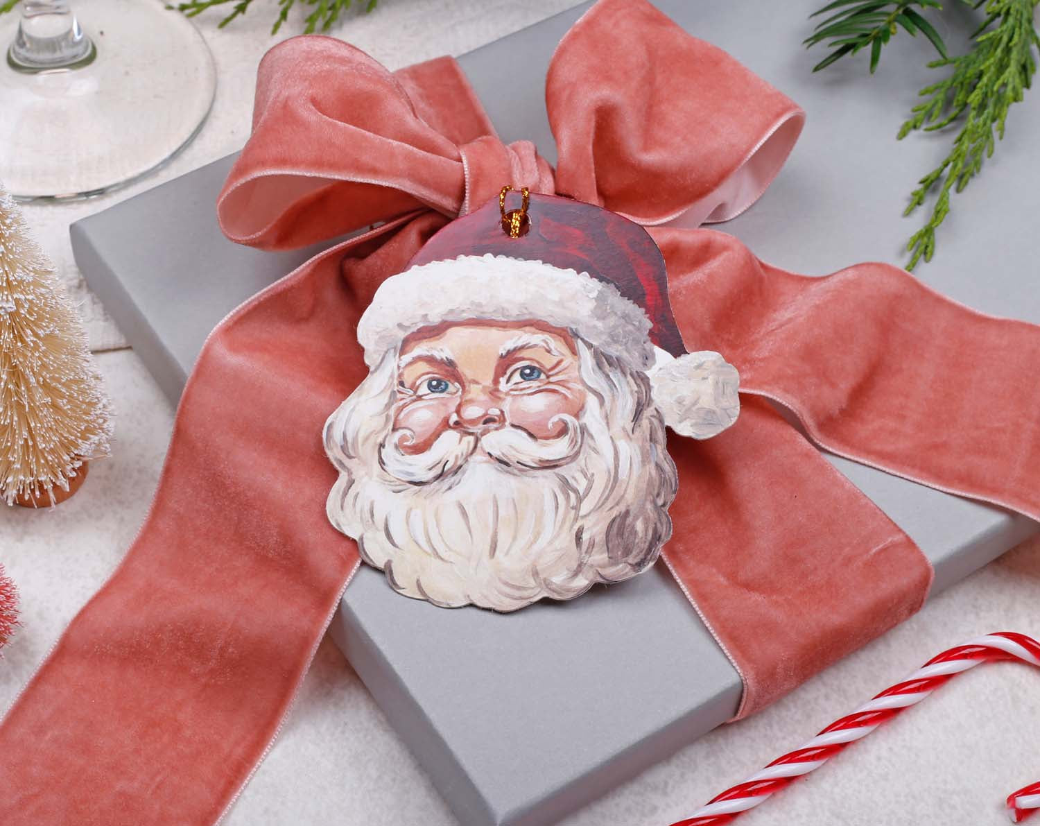 Plastic Free Christmas gift wrap with a vintage Santa decoration and eco-friendly ribbon.