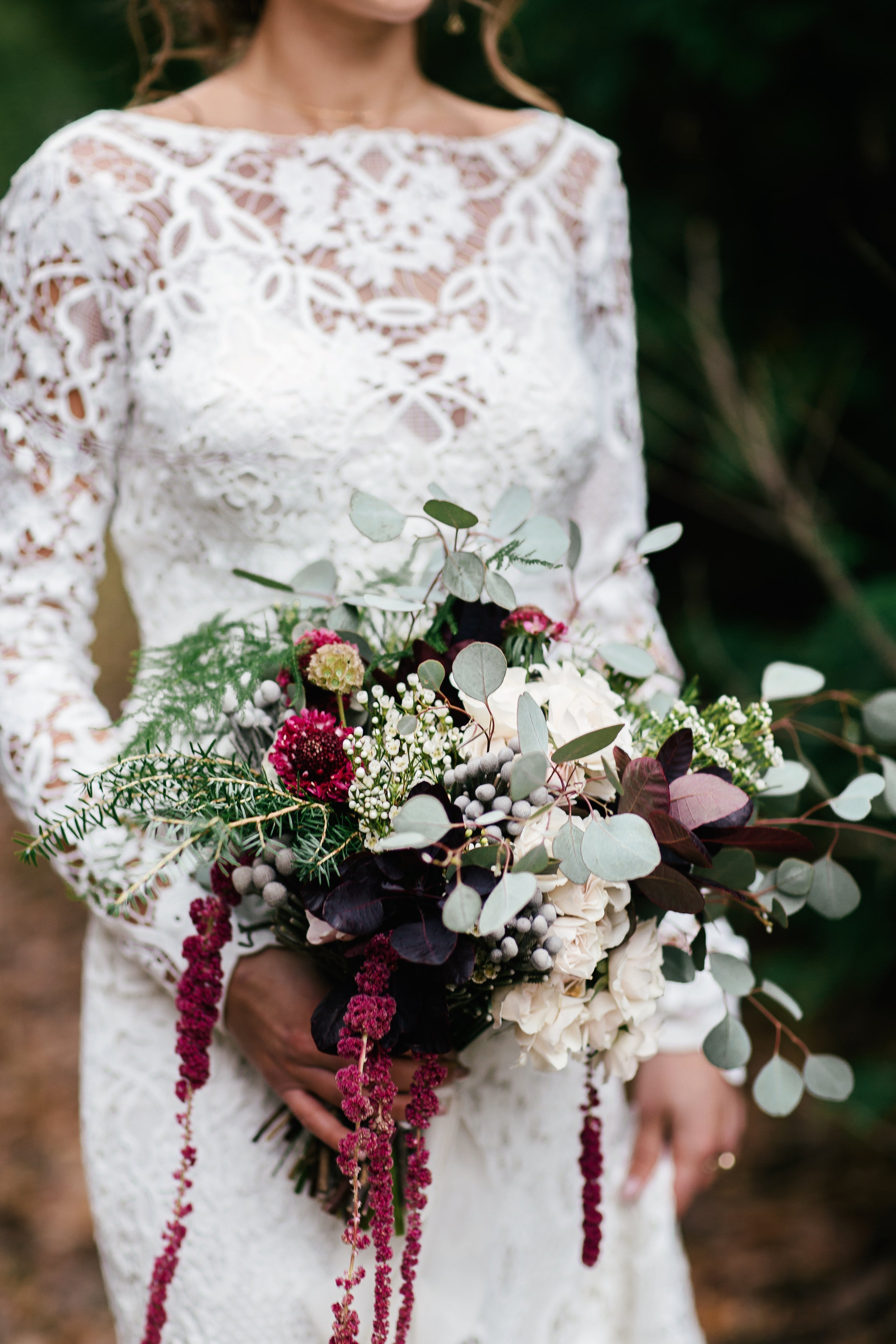 Gothic Wedding Stationery featuring a bride holding a dark romantic bouquet, showcasing deep colors and unique floral arrangements.