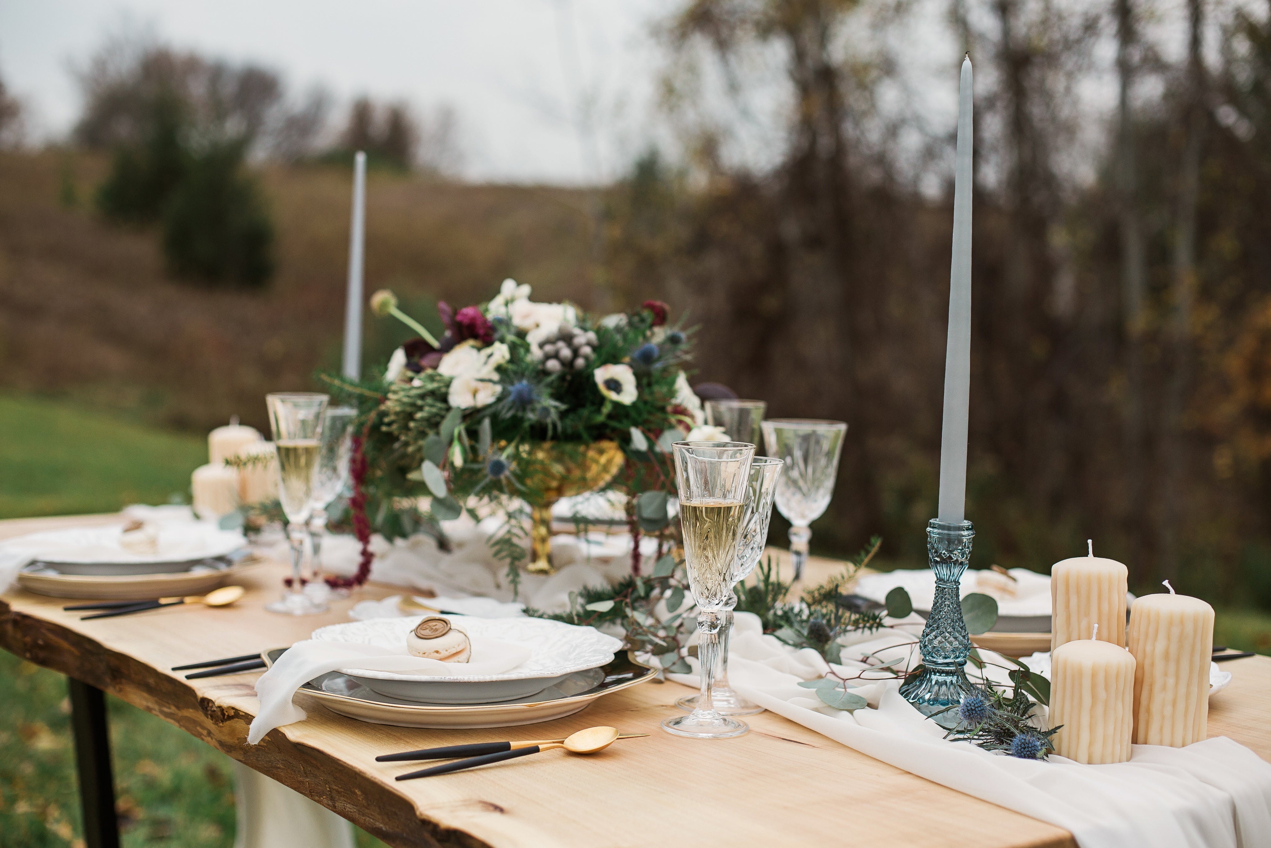 Elegant wedding table stationery arrangement with floral centerpiece and decorative candles.