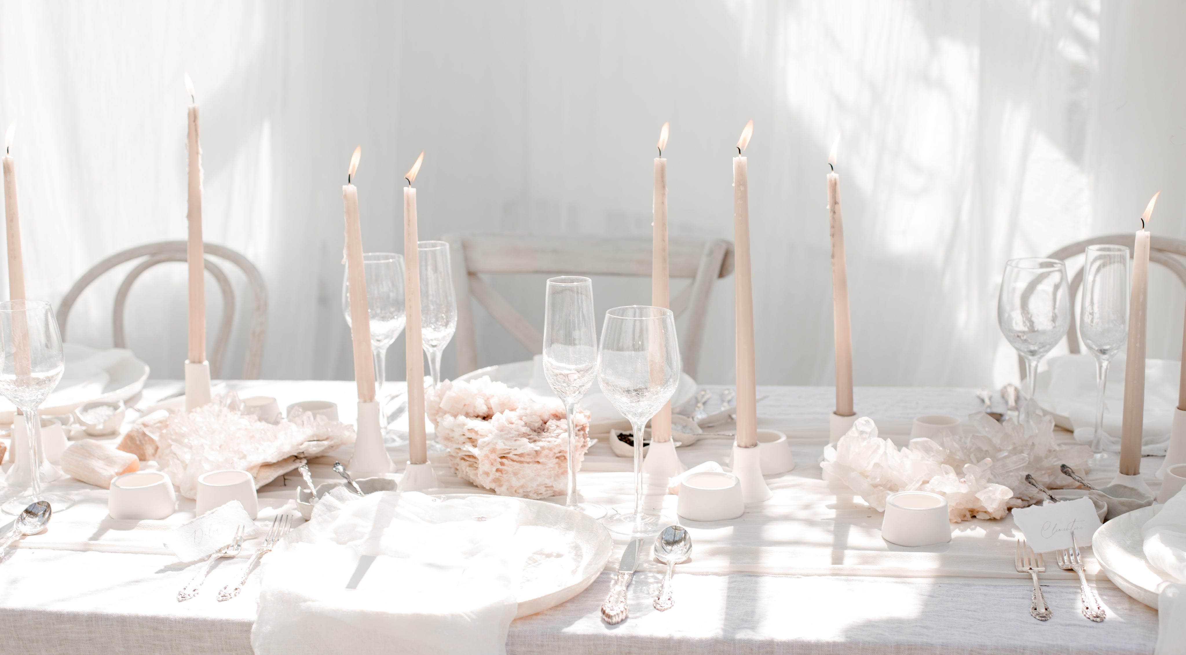 Minimalist Wedding decor table setting with candles and elegant glassware for a stylish celebration.