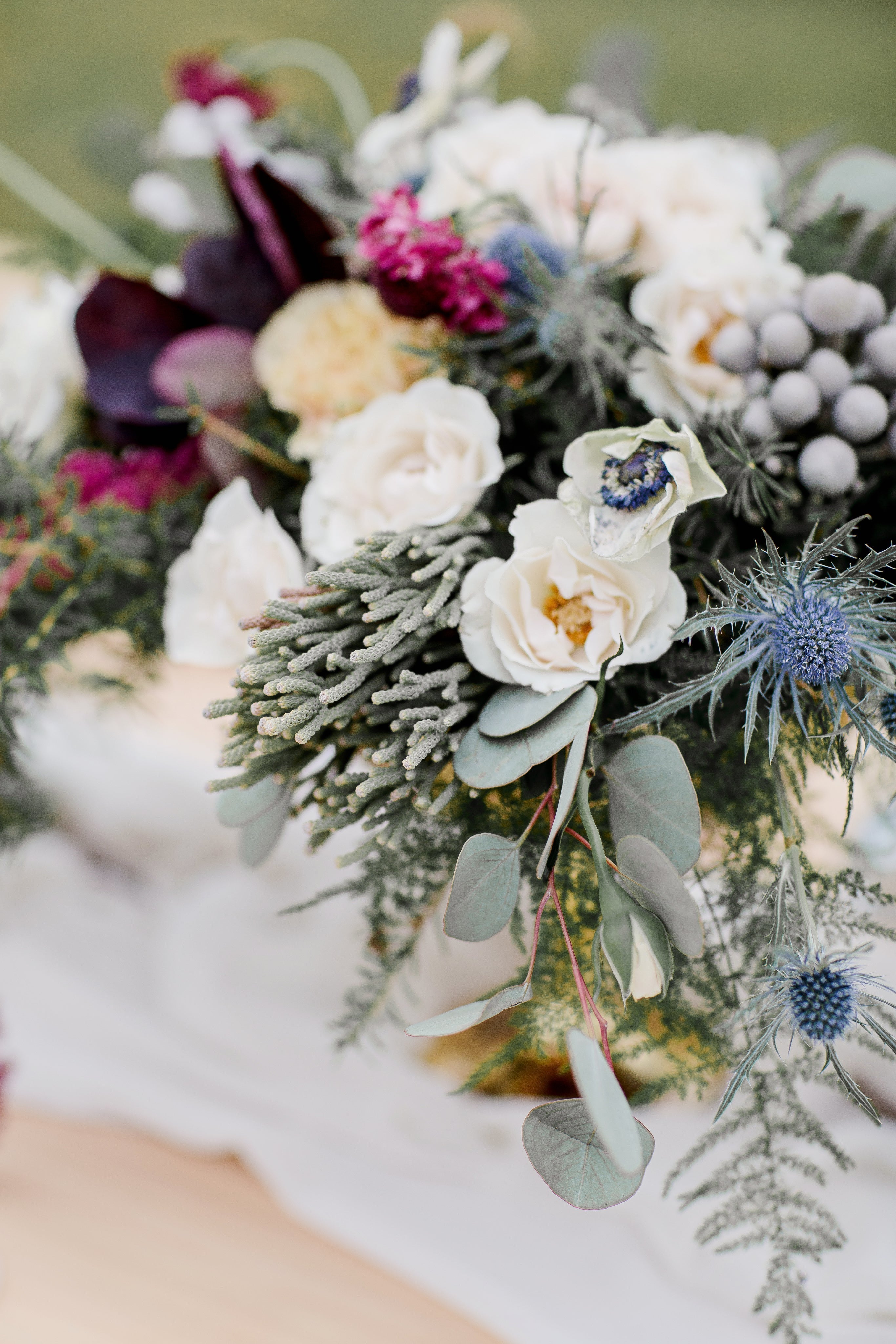 Beautiful floral centerpiece featuring various blooms and greenery for wedding stationery mistakes.