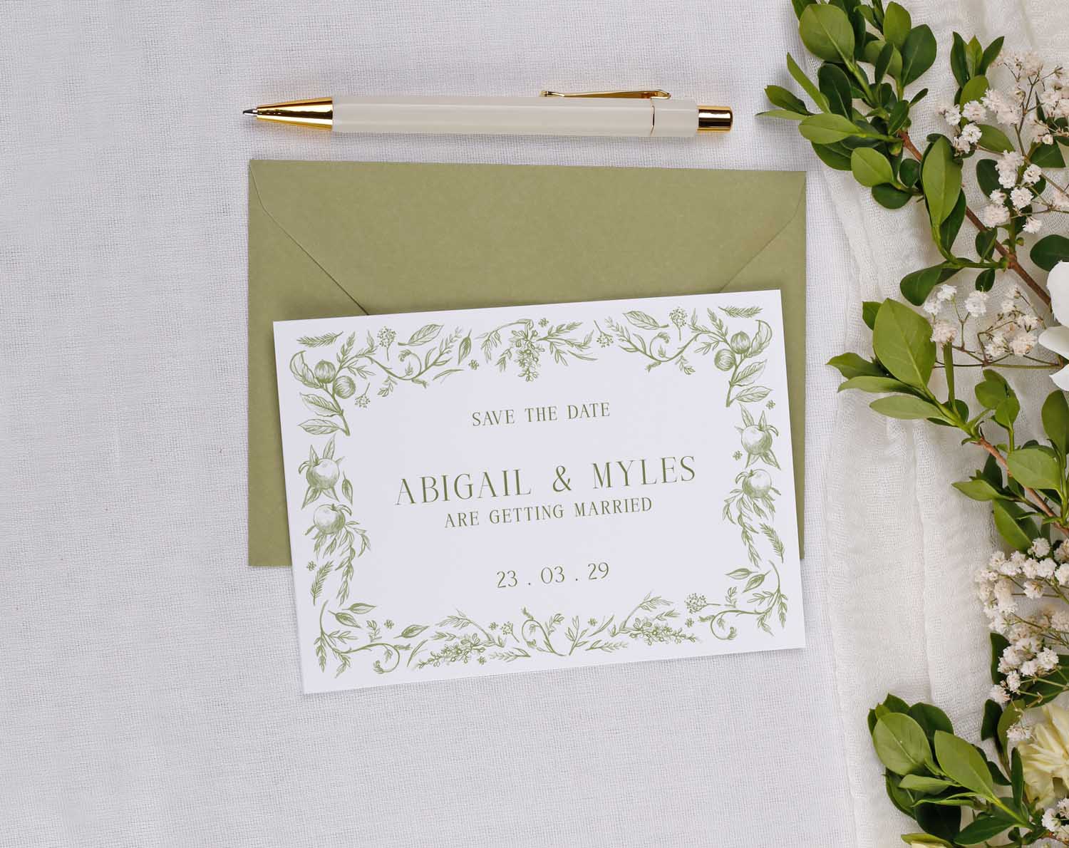 Save the Date Cards featuring floral design for weddings with a green envelope and pen.