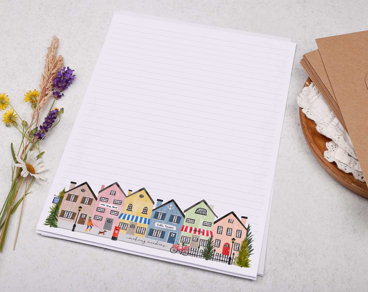 A4 letter writing paper sheets with a cute illustration of a street lined with colourful houses and shops.