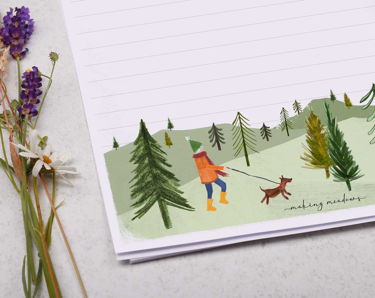 A4 letter writing paper sheets with a cute illustration of a dog walker surrounded by rolling hills and countryside. 