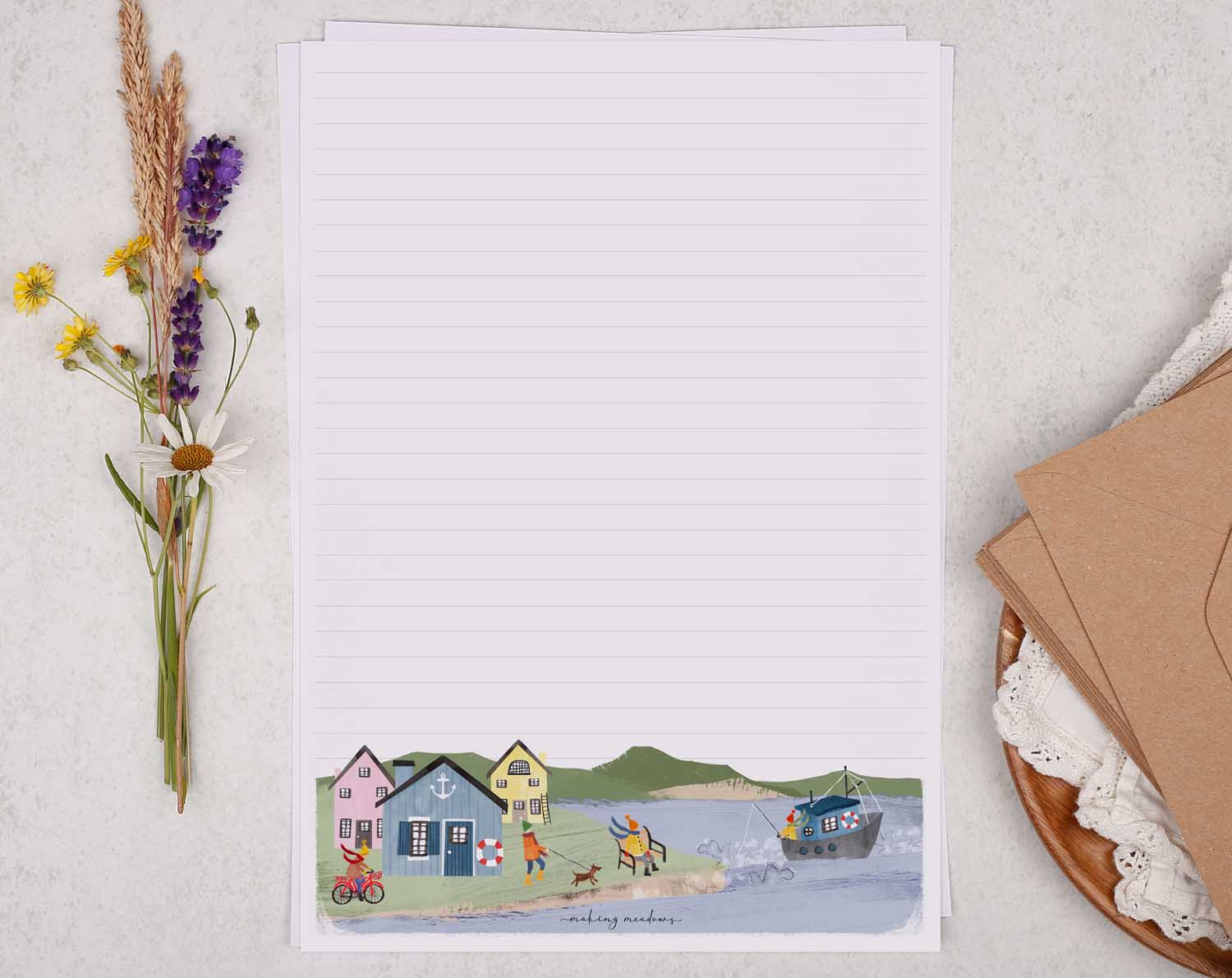 A4 letter writing paper sheets with a cute illustration of an English seaside town surrounded by rolling cliffs.