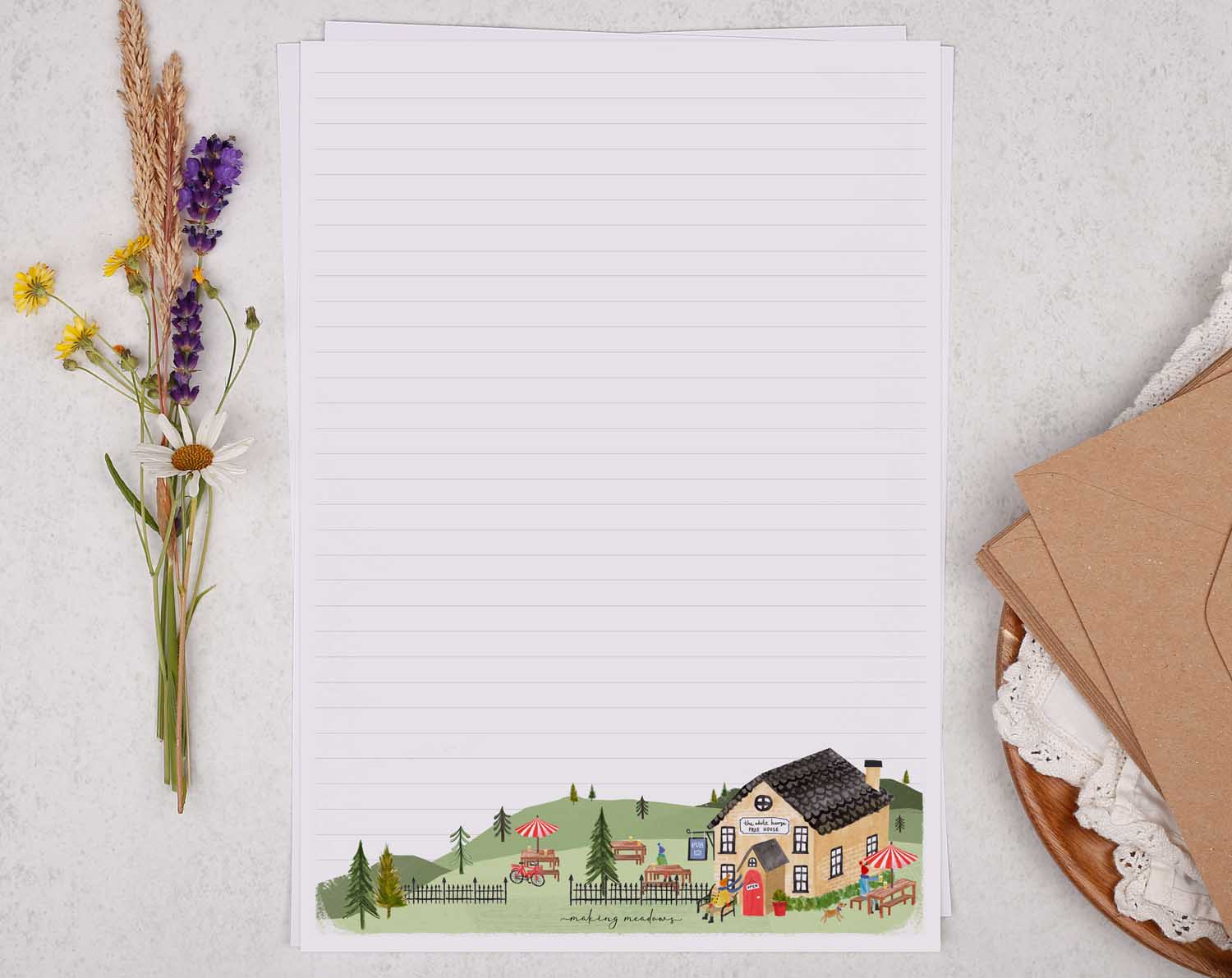 A4 letter writing paper sheets with a cute illustration of a countryside pub surrounded by rolling hills.